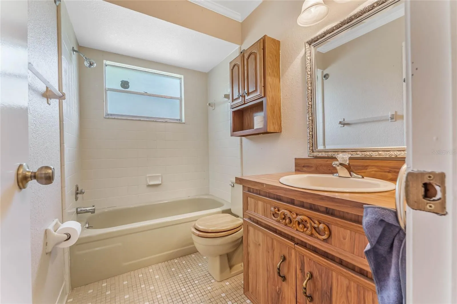 primary bathroom with brown cabinets